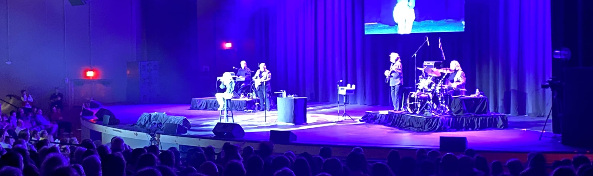 signer on stage in chair washed out by the lights Birmingham